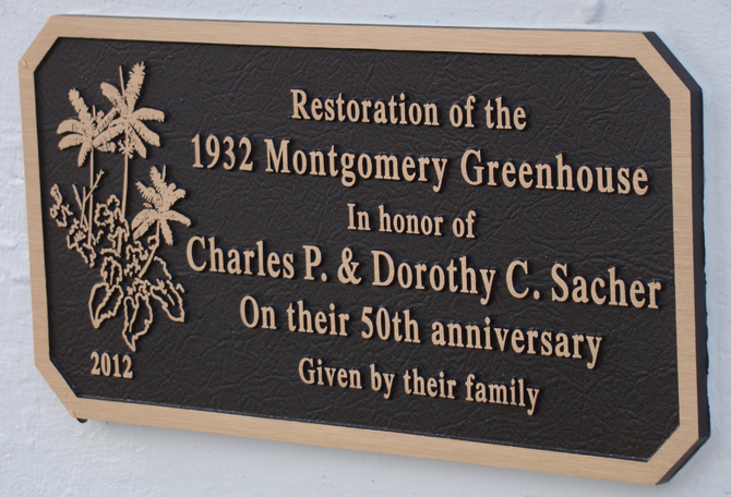 Plaque reads: Restoration of the 1932 Montgomery Greenhouse in honor of Charles P. & Dorothy C. Sacher on their 50th Anniversary, given by their family.